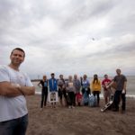 Portrait of Stephen Love at Euclid Beach, Cleveland, Ohio. Stephen is a team leader for the Adopt A beach Program, which is supported by the Alliance for the Great Lakes. Pictured with Stephen in the background is some of the team which cleaned the beach on a recent morning.