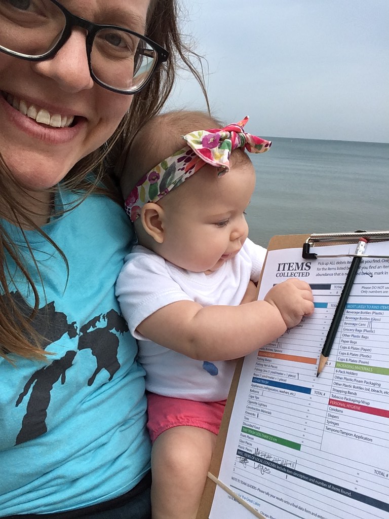 Woman and small baby in front of water