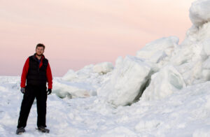 James Kessler stands on an ice-covered section of Lake Superior