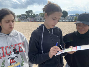 Adopt-a-Beach volunteers record litter data on the beach.