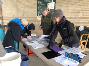 Volunteers sign in for an Adopt-a-Beach cleanup.