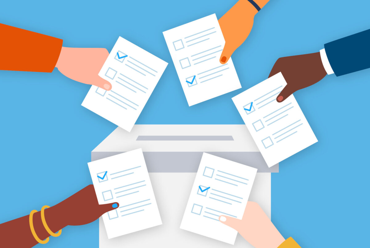 Hands casting ballots.