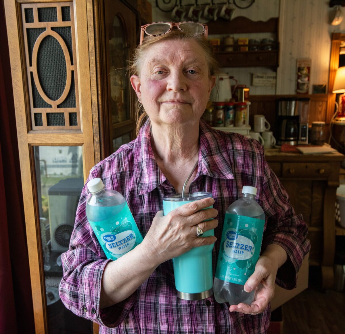 Mary Warner of Nekoosa, Wisconsin, with bottled water she is required to purchase as her well is currently testing above the federal regulatory standard of 10mg/L for nitrate.