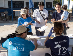 Volunteers sign in for a beach cleanup.