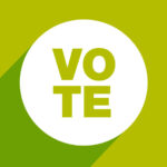 A sticker that says "vote"