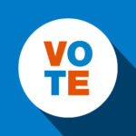A sticker that says "vote"